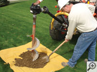 Auguring a hole in the earth for a foundation repair in Cortez