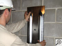 Mounting a foundation wall plate for an earth anchor installation in Craig.