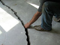 a severely damaged cracked concrete slab floor in Vail