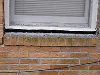 A window sill cracking and separating from the foundation wall in a New Castle home.