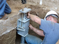 Foundation repair contractors installing the foundation bracket in Grand Junction.