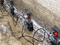 Using foundation push piers to lift a foundation during a repair in Glenwood Springs.